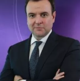 Man in a suit with a purple background.